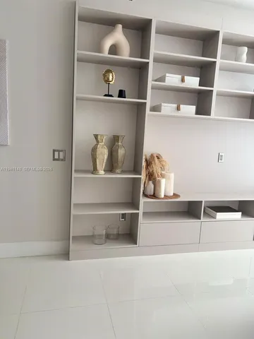 a room with a book shelf with a book shelf