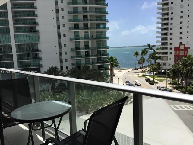 a view of a balcony with table and chairs