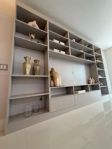 a view of an empty room with cabinet