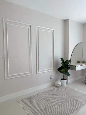 a view of a room that has a potted plant and wooden floor