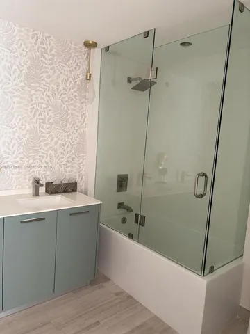 a bathroom with a bathtub and a sink