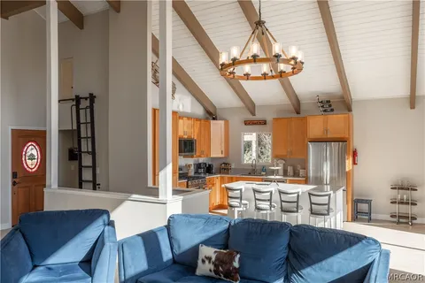 a dining room with furniture a chandelier and wooden floor