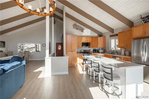 a large kitchen with a table and chairs