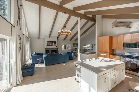 a kitchen with stainless steel appliances granite countertop a sink stove and a refrigerator