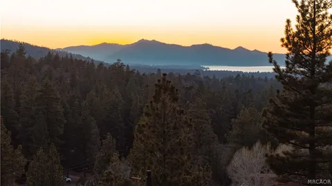 a view of a house with a mountain and a forest
