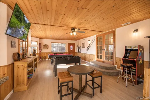 a room with furniture pool table and flat screen tv
