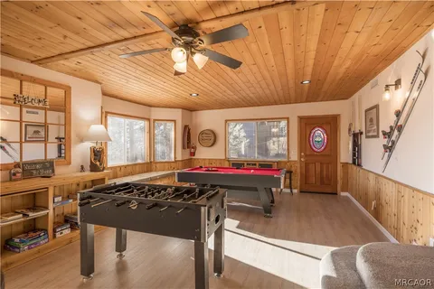 a kitchen with stainless steel appliances granite countertop a stove and a dining table with white cabinets