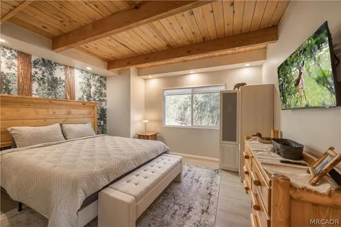 a bed sitting in a bedroom next to a window