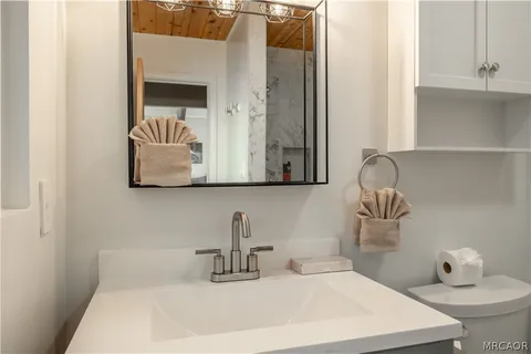 a dining room with furniture a rug and a chandelier