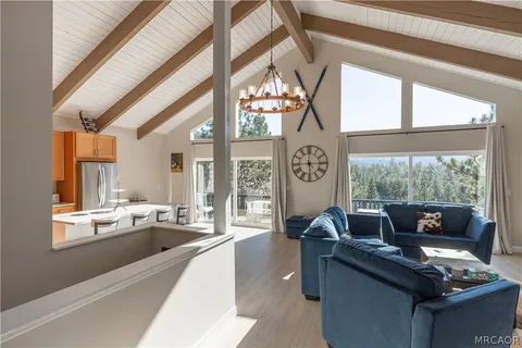 a living room with furniture and large windows