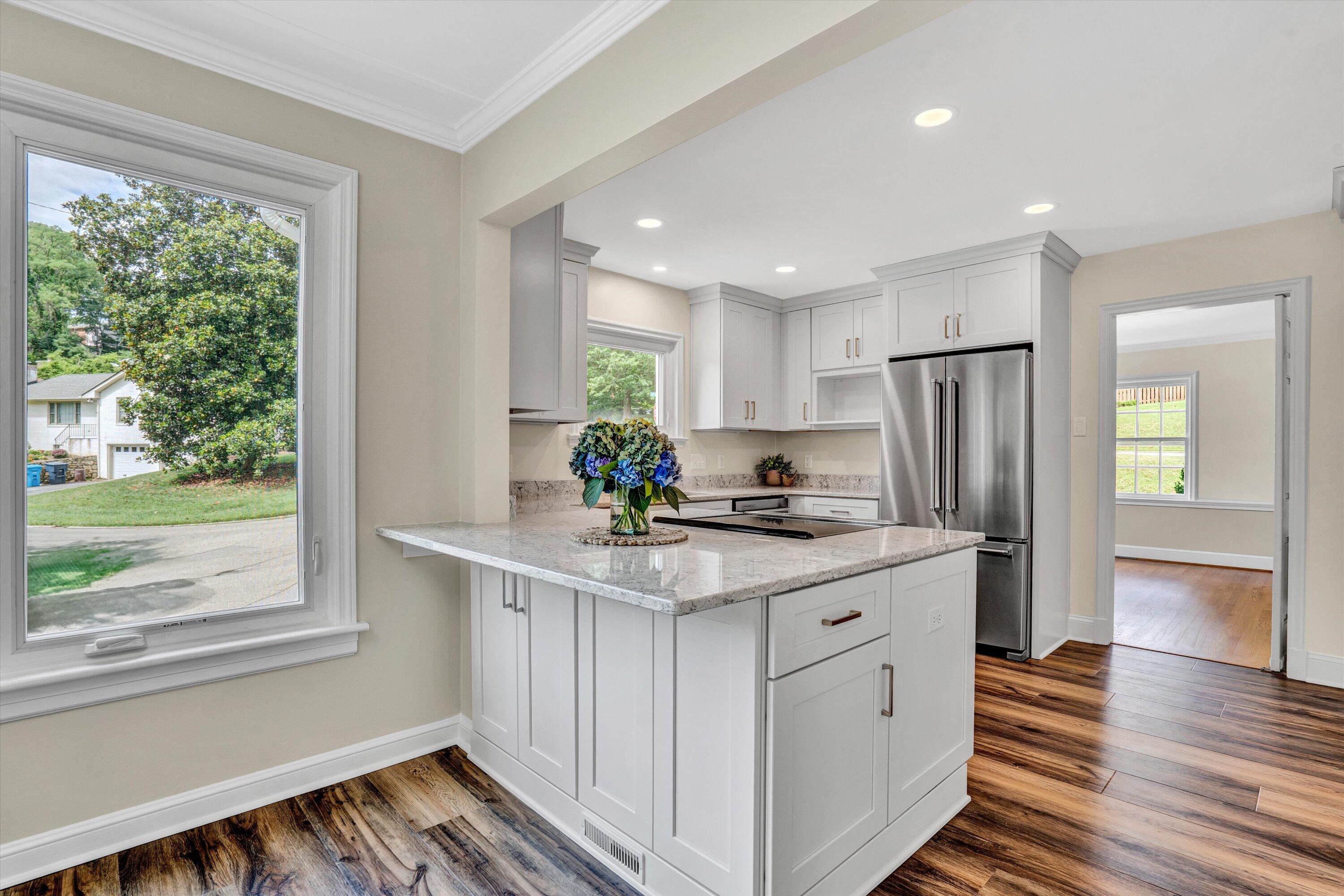 2118 Mt Vernon Road Southwest Roanoke, VA 24015 - Photo 14 of 53 a kitchen with kitchen island white cabinets and refrigerator with wooden floor