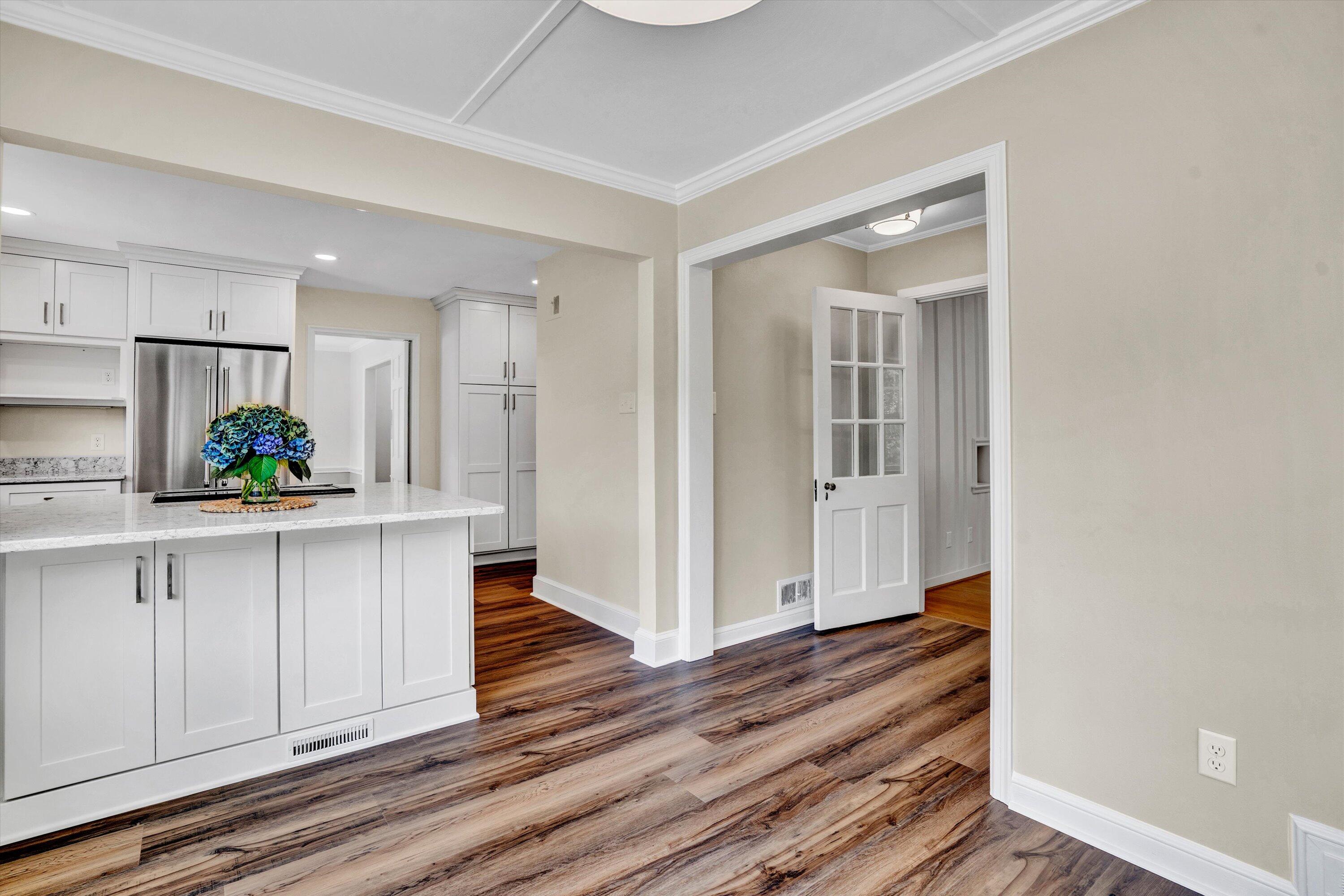2118 Mt Vernon Road Southwest Roanoke, VA 24015 - Photo 16 of 53 a kitchen with white cabinets and wooden floor