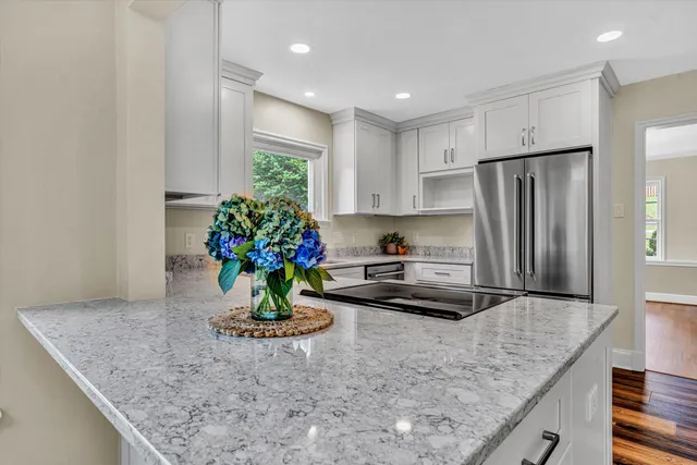 a kitchen with a refrigerator sink and cabinets