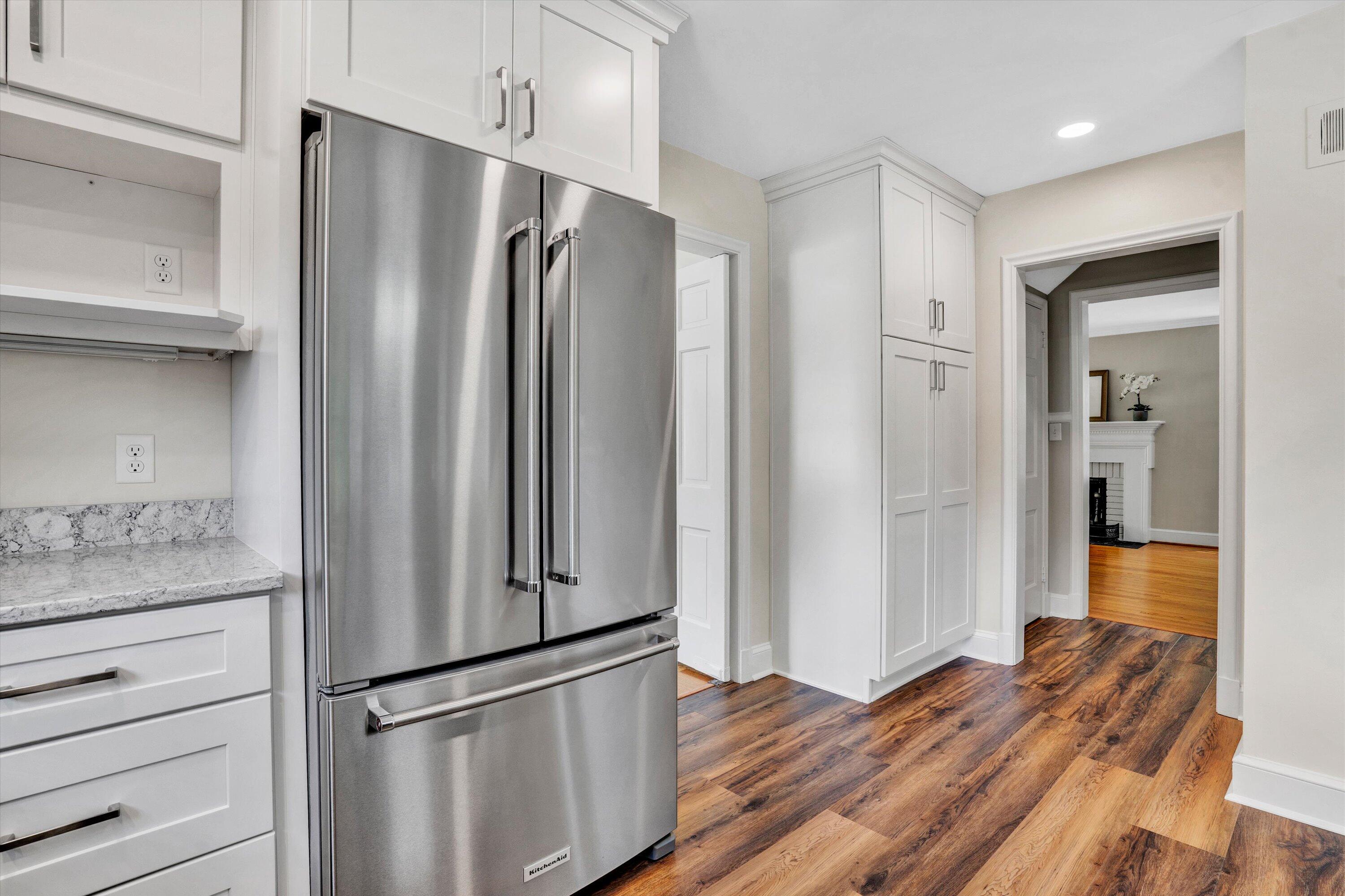 2118 Mt Vernon Road Southwest Roanoke, VA 24015 - Photo 23 of 53 a kitchen with stainless steel appliances a refrigerator and wooden floor
