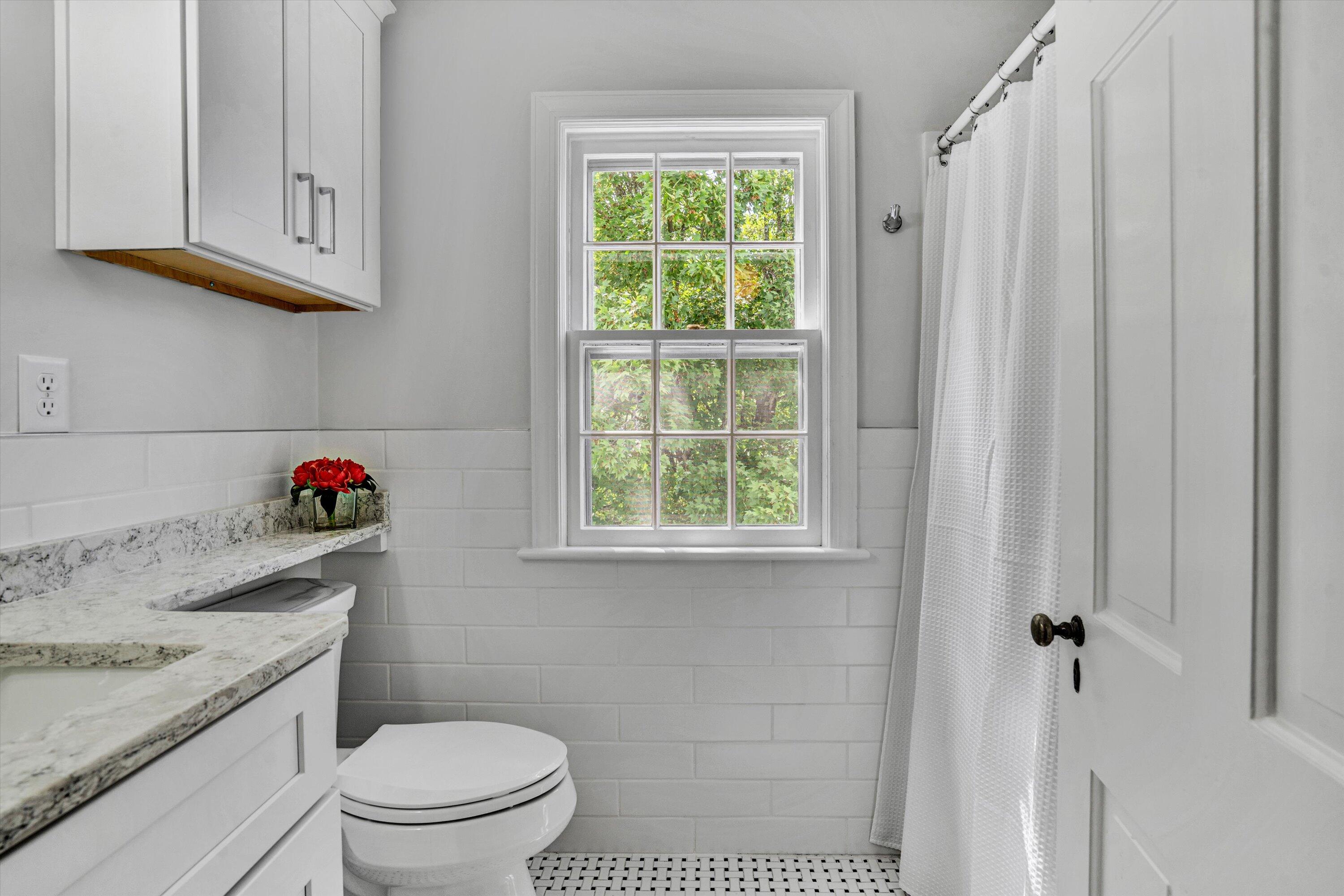 2118 Mt Vernon Road Southwest Roanoke, VA 24015 - Photo 27 of 53 a bathroom with a sink toilet and window
