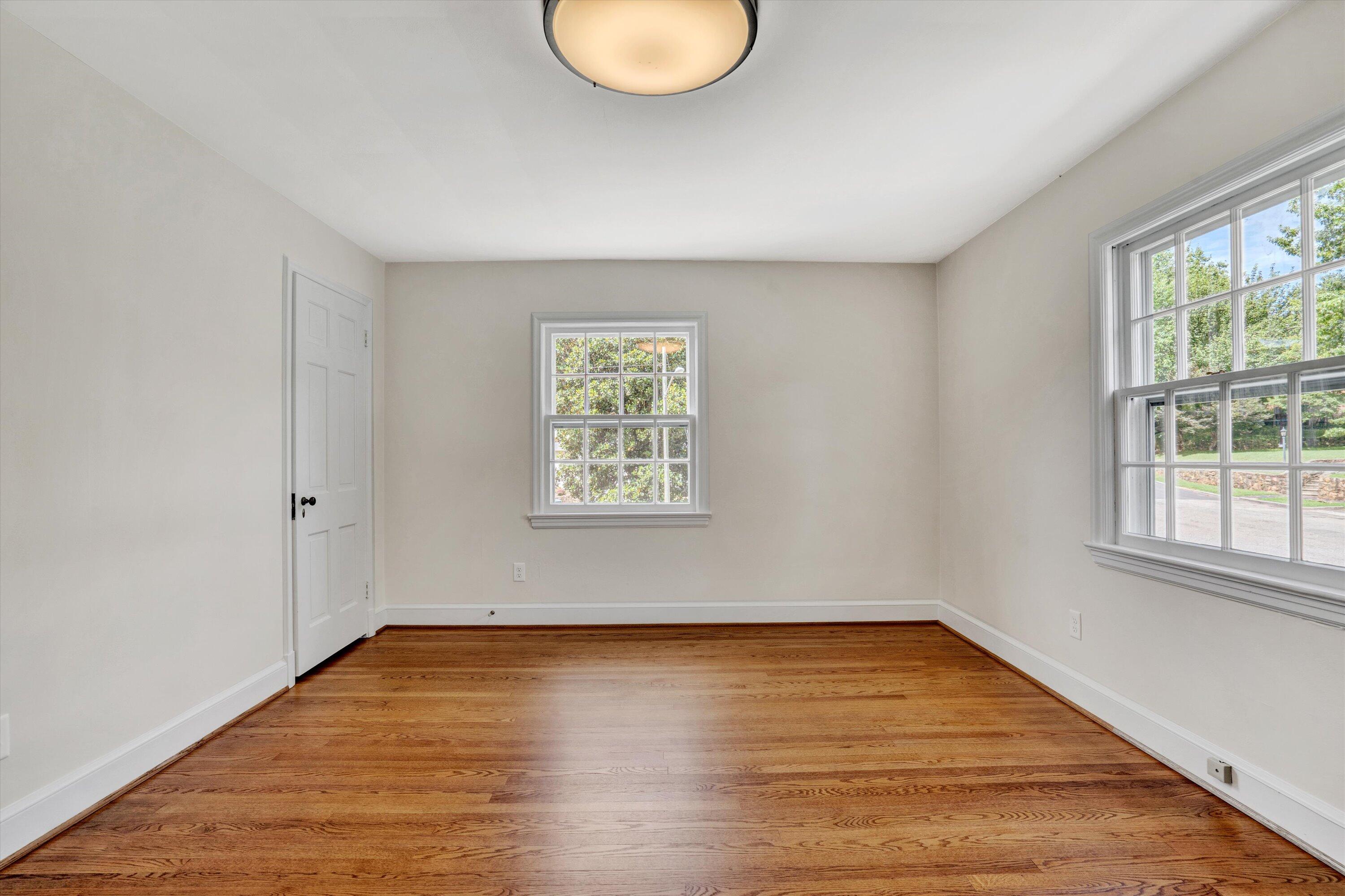 2118 Mt Vernon Road Southwest Roanoke, VA 24015 - Photo 32 of 53 an empty room with wooden floor and windows