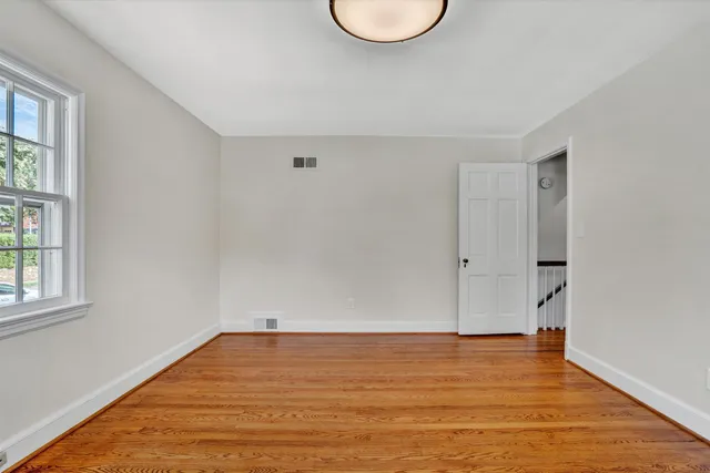 a bathroom with a granite countertop sink and a toilet