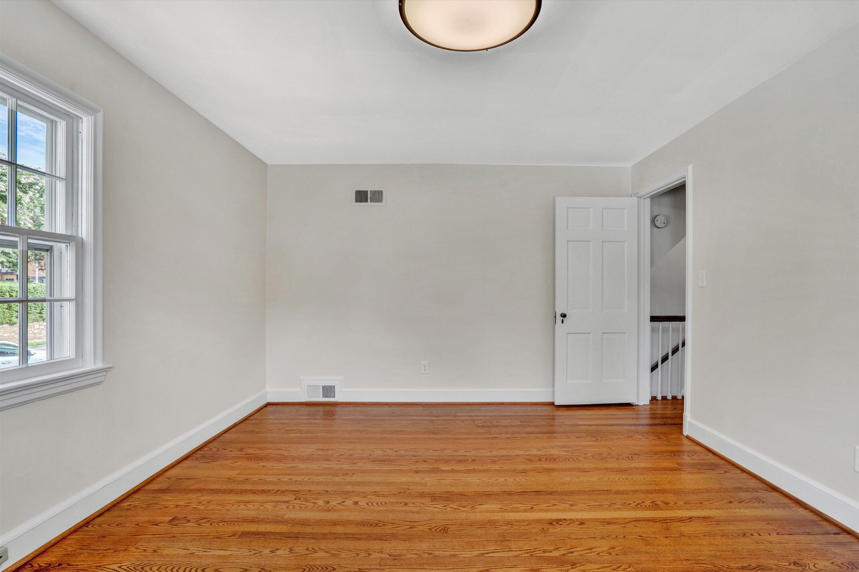2118 Mt Vernon Road Southwest Roanoke, VA 24015 - Photo 33 of 53 a view of an empty room with wooden floor and a window