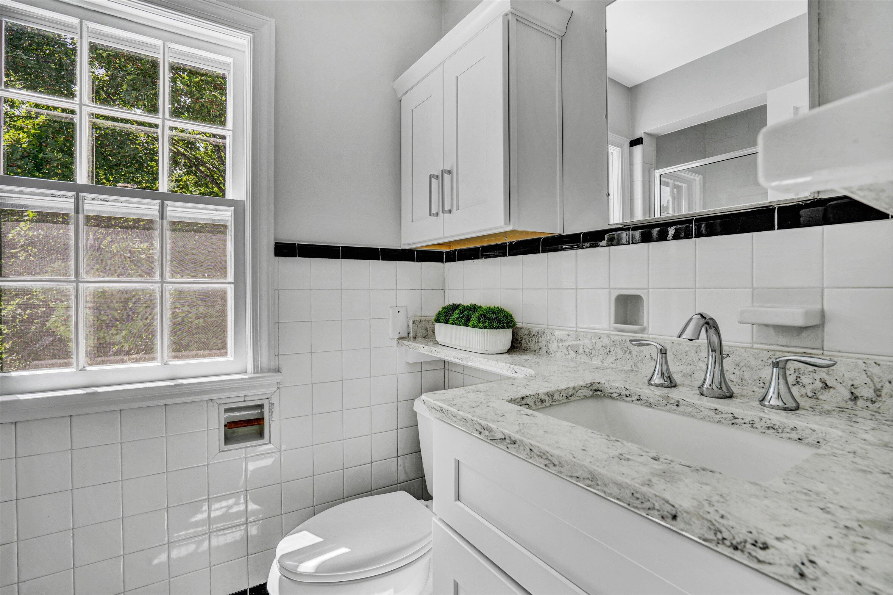 2118 Mt Vernon Road Southwest Roanoke, VA 24015 - Photo 35 of 53 a bathroom with a granite countertop sink a toilet and a mirror
