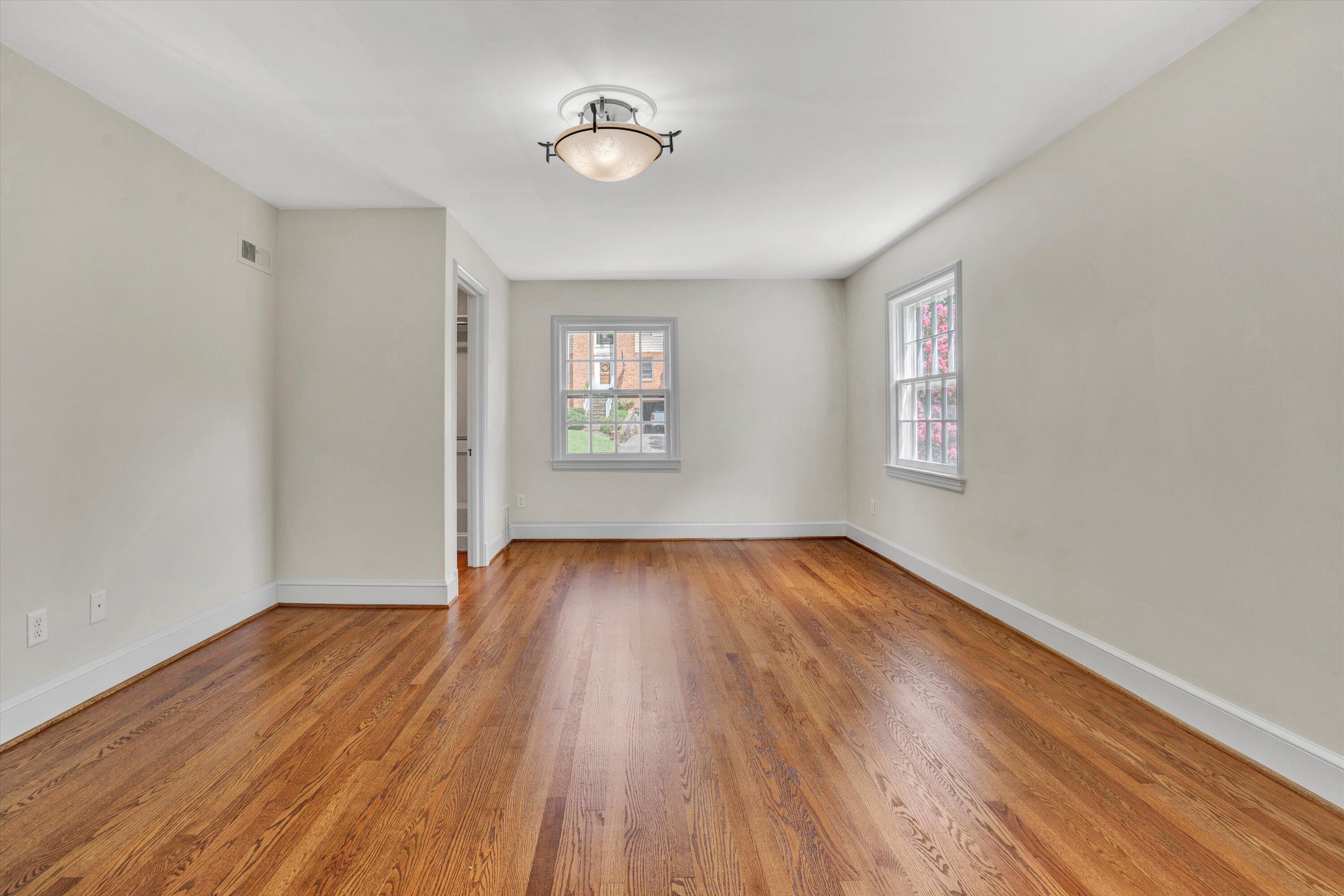 2118 Mt Vernon Road Southwest Roanoke, VA 24015 - Photo 36 of 53 an empty room with wooden floor and windows