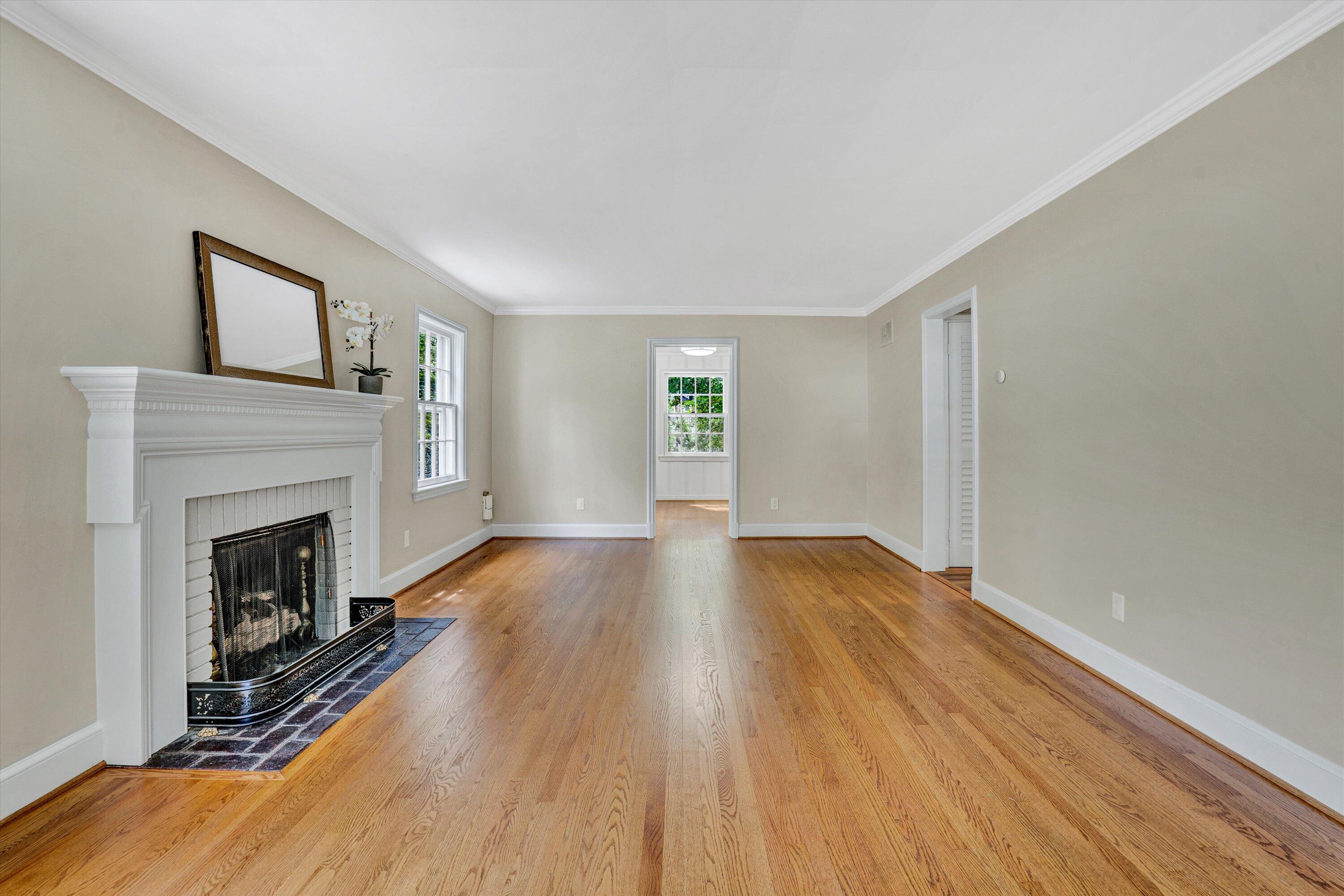 2118 Mt Vernon Road Southwest Roanoke, VA 24015 - Photo 4 of 53 a view of an empty room with wooden floor fireplace and a window