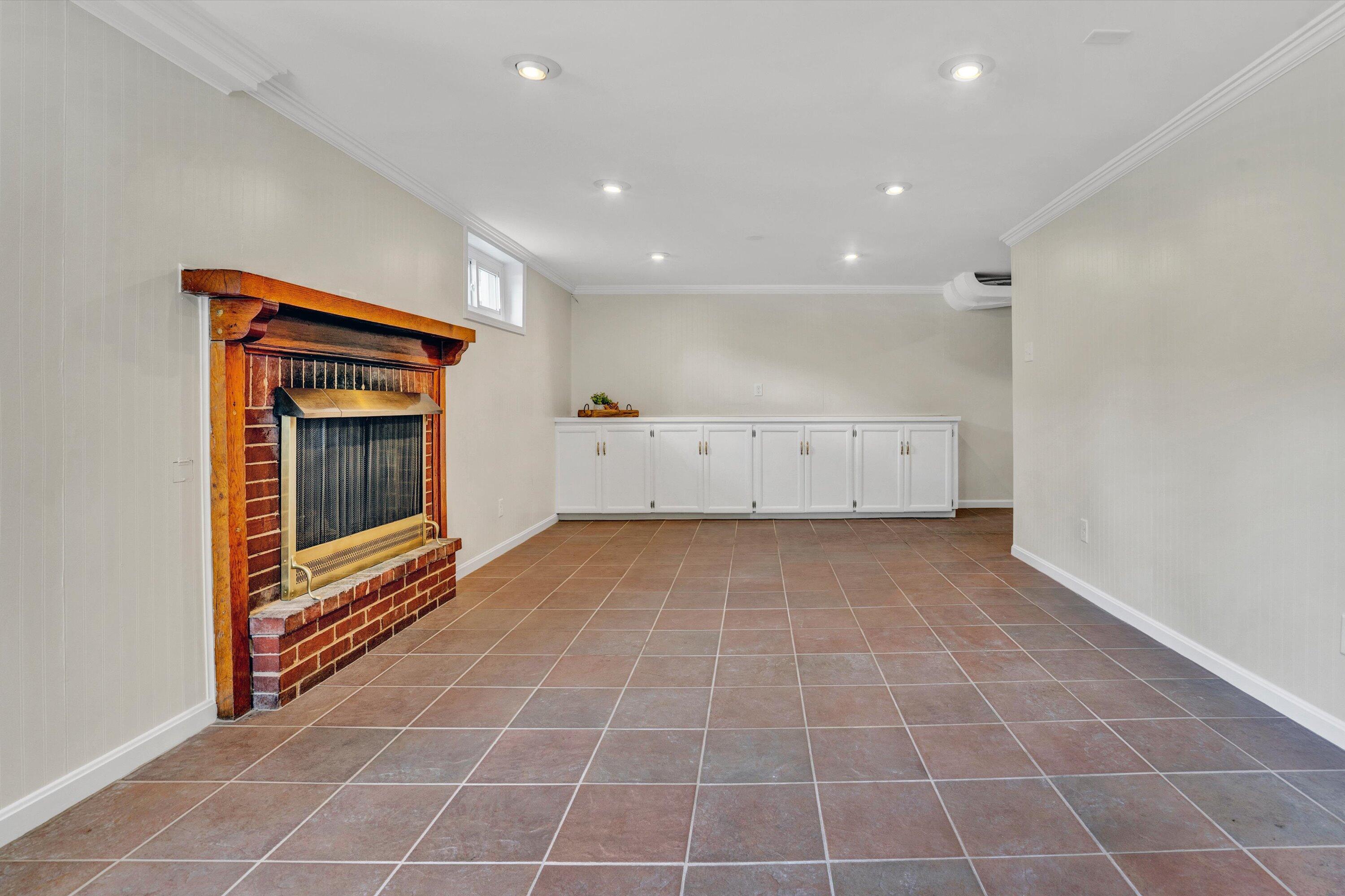 2118 Mt Vernon Road Southwest Roanoke, VA 24015 - Photo 43 of 53 a view of an empty room with a fireplace and a window