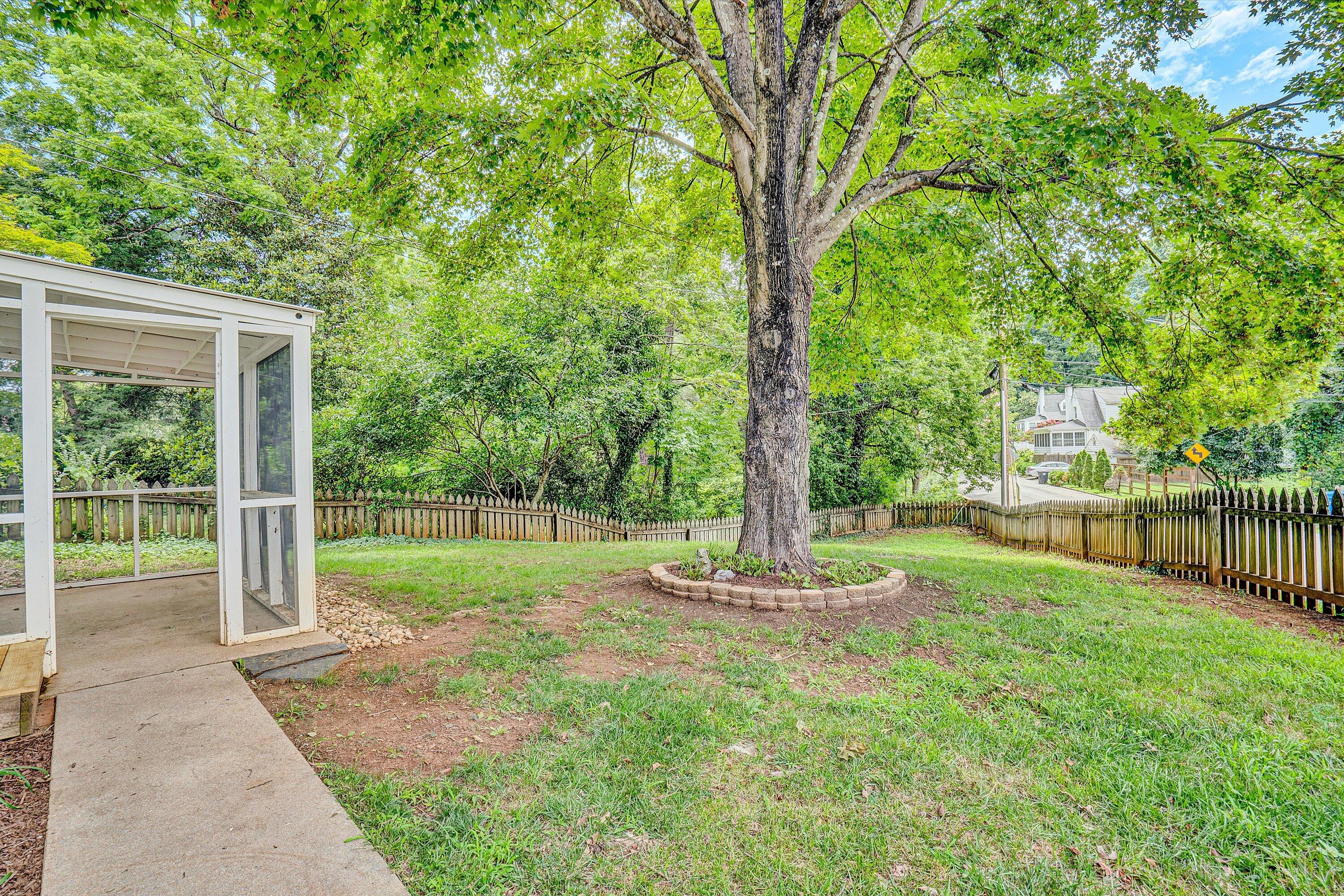 2118 Mt Vernon Road Southwest Roanoke, VA 24015 - Photo 48 of 53 a backyard of a house with lots of plants and large tree