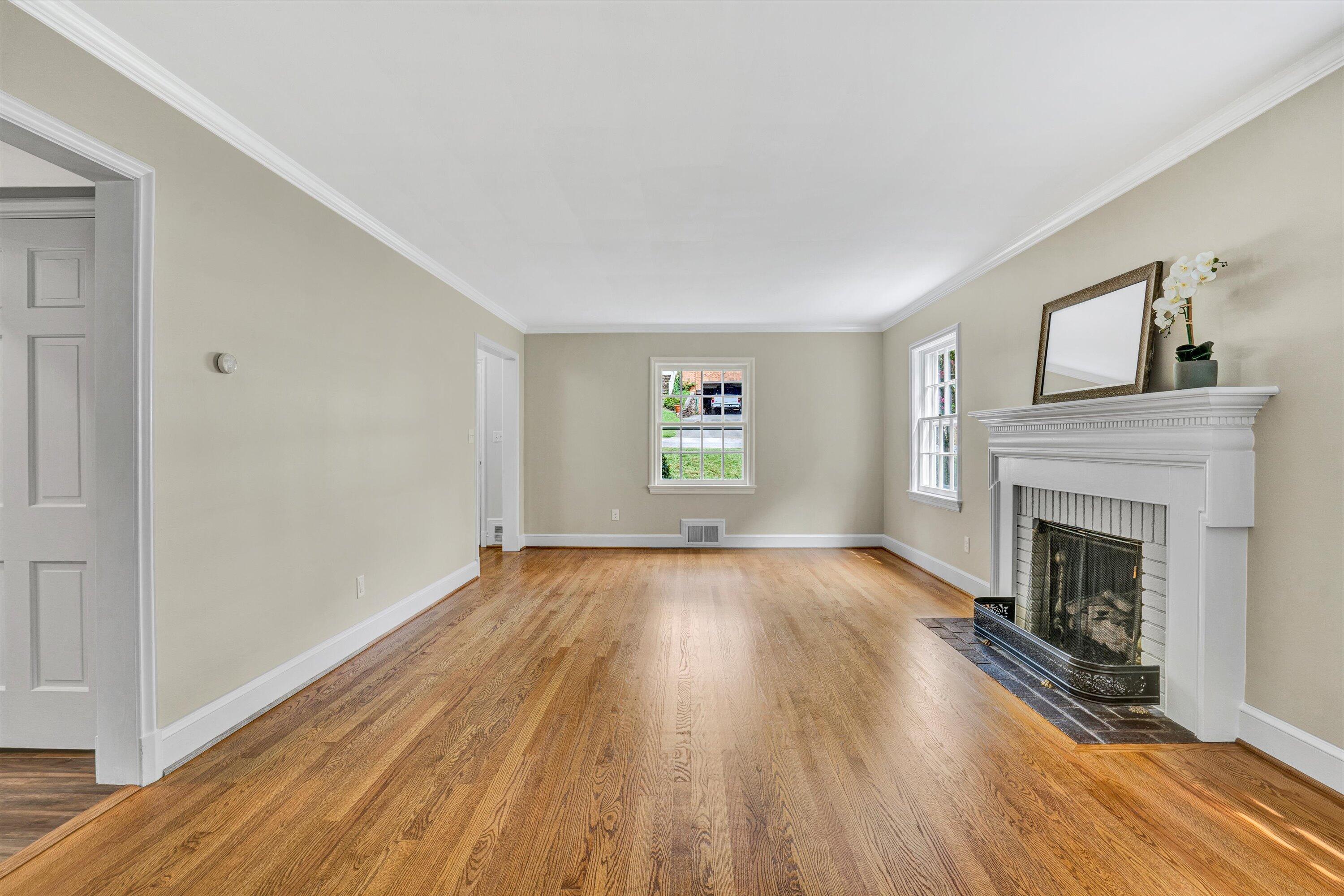 2118 Mt Vernon Road Southwest Roanoke, VA 24015 - Photo 6 of 53 a view of empty room with wooden floor and fireplace