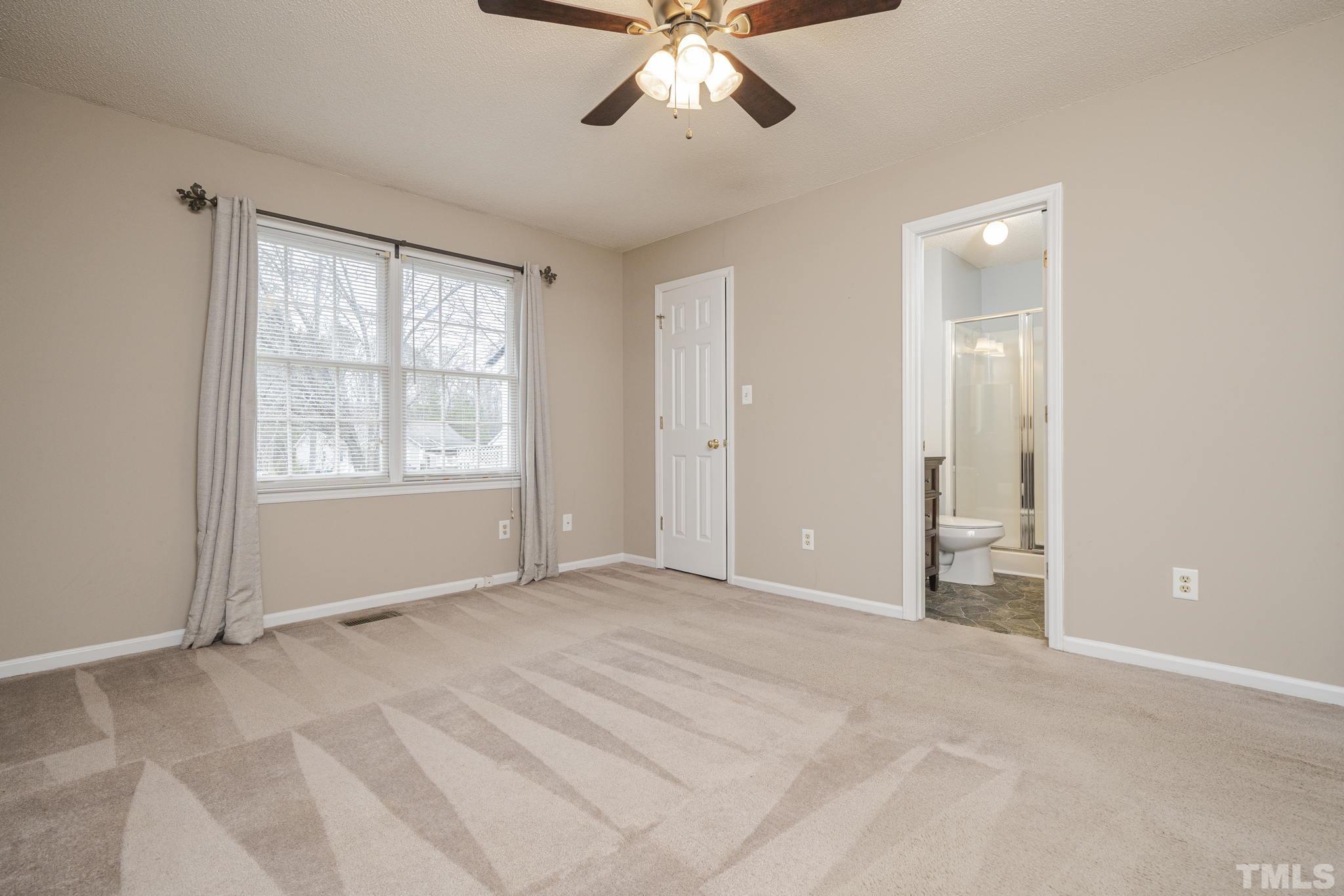 105 Pineview Drive Zebulon, NC 27597 - Photo 17 of 29 a view of an empty room with window and a kitchen