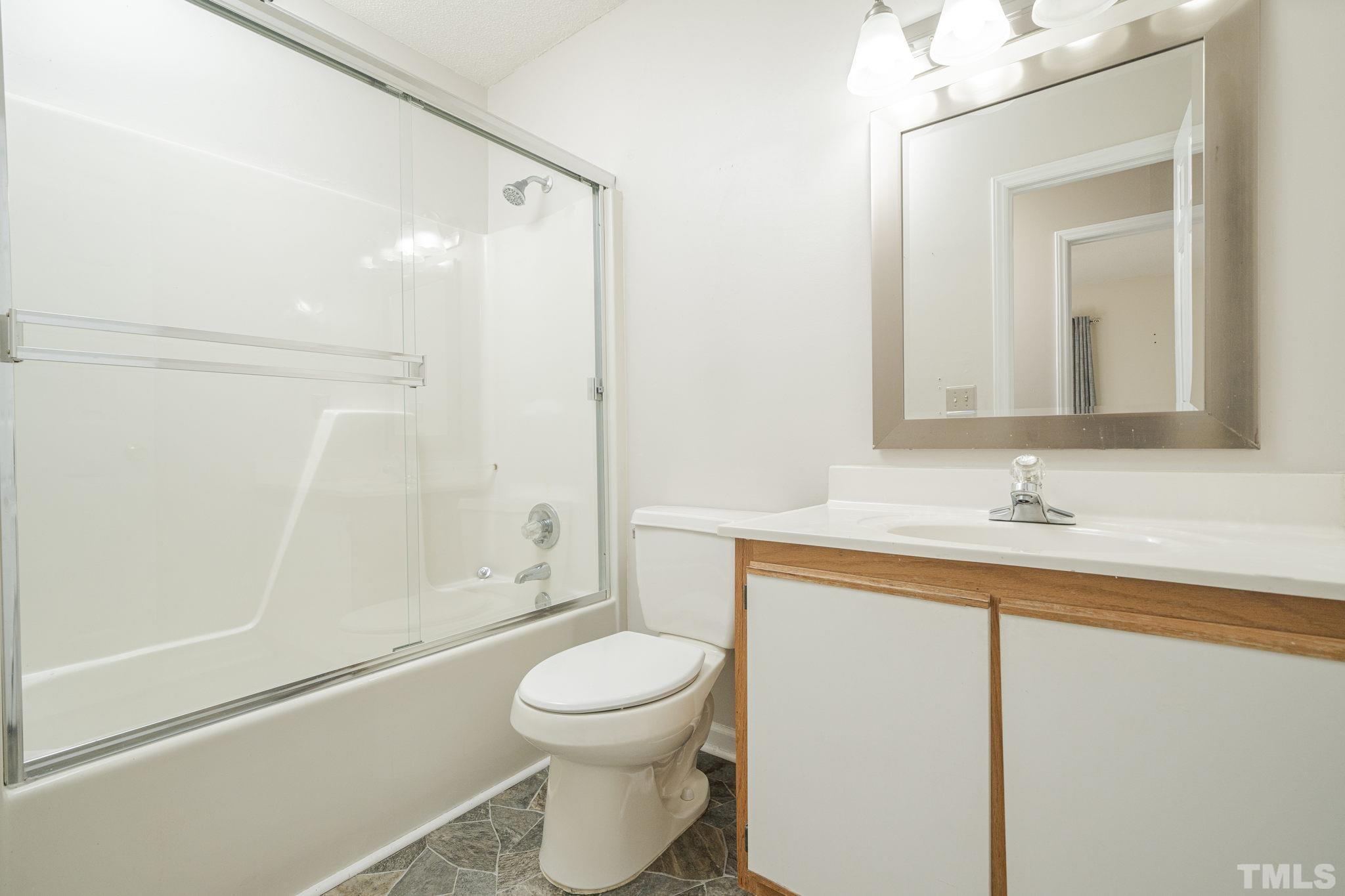 105 Pineview Drive Zebulon, NC 27597 - Photo 20 of 29 a bathroom with a toilet a sink and a bathtub