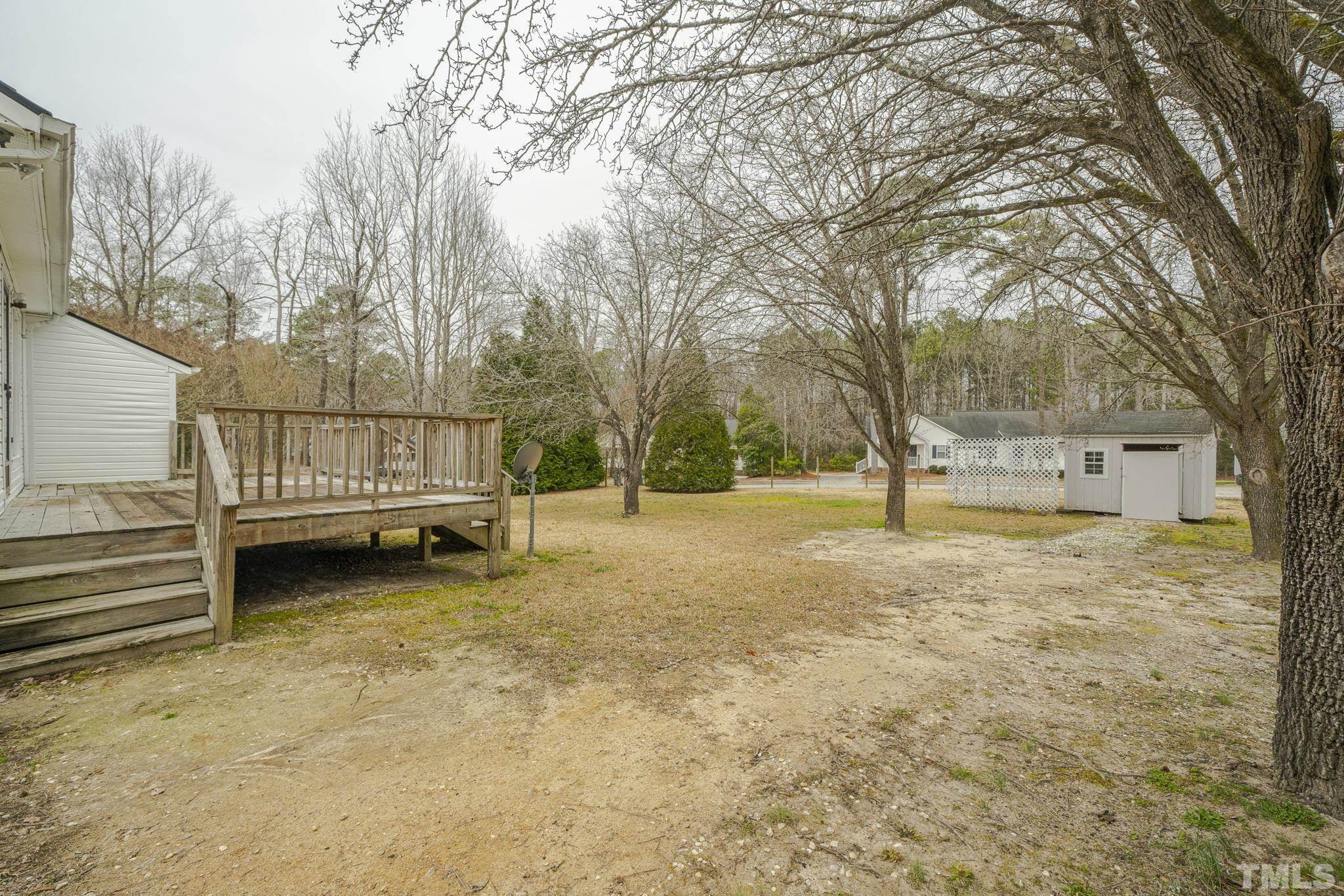 105 Pineview Drive Zebulon, NC 27597 - Photo 24 of 29 a view of a yard with a tree