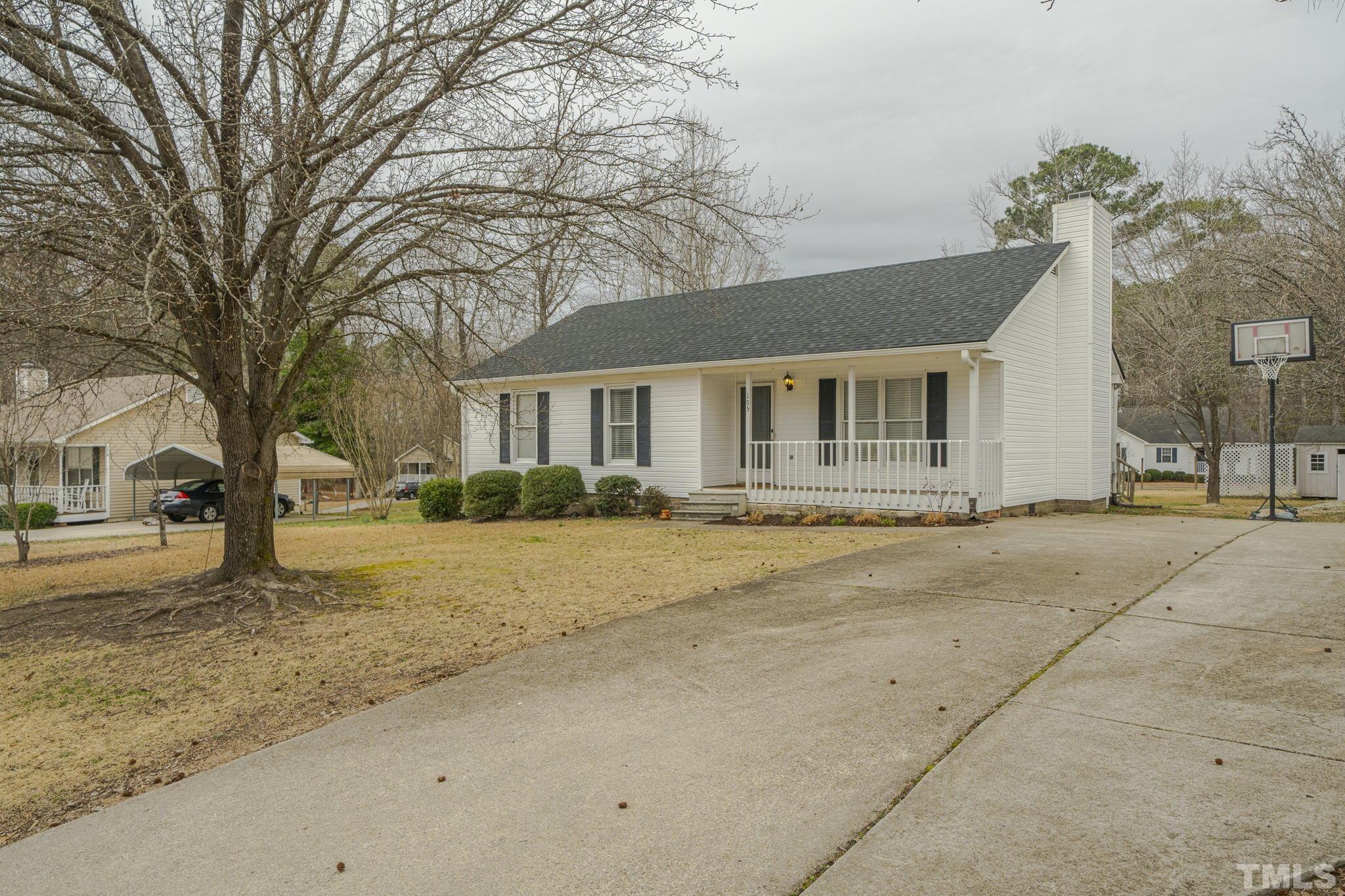 105 Pineview Drive Zebulon, NC 27597 - Photo 4 of 29 a house with a tree in front of it