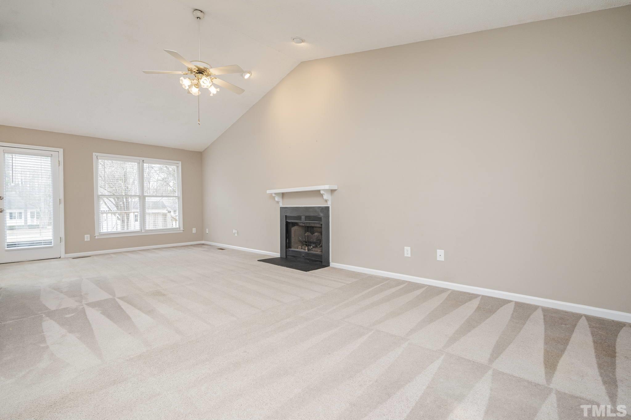 105 Pineview Drive Zebulon, NC 27597 - Photo 7 of 29 an empty room with windows and fireplace