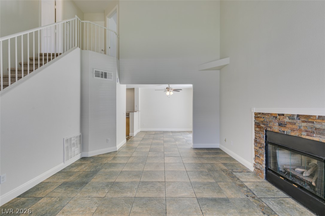 200 Luninborg Street Henderson, NV 89074 - Photo 9 of 40 A spacious common area with high ceilings and a cozy fireplace, perfect for gatherings.