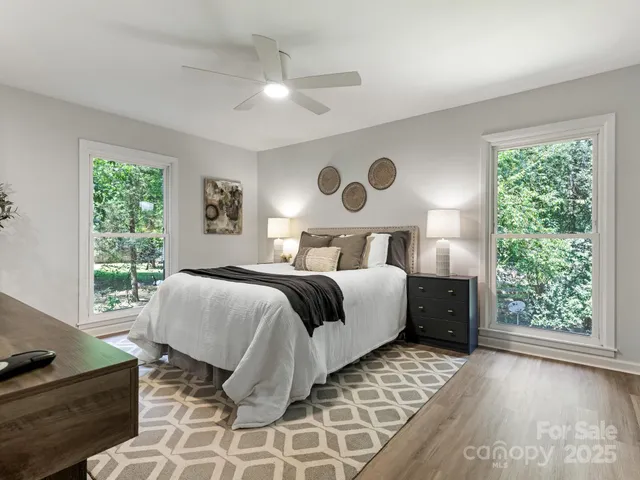 a bedroom with a bed and a table with wooden floor