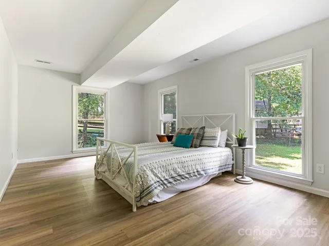 a bathroom with a granite countertop sink a toilet and a mirror