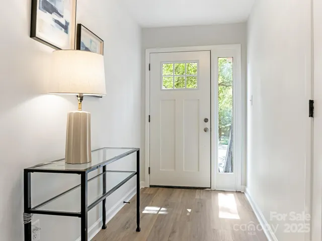 a kitchen with kitchen island a refrigerator a stove a sink and a chandelier