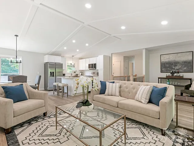 a view of a livingroom with furniture and floor to ceiling window