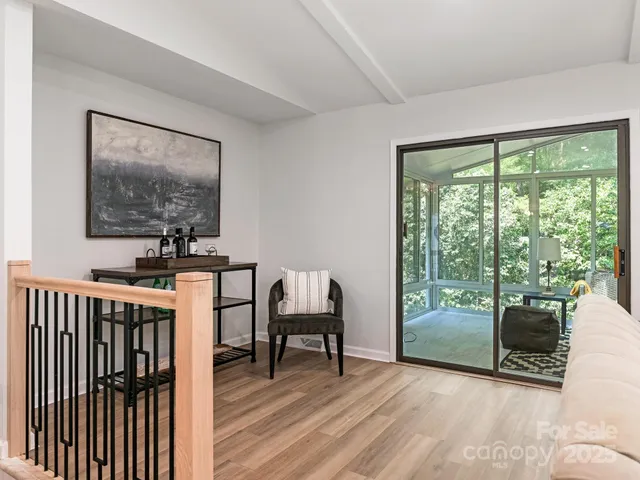 a living room with furniture and floor to ceiling windows