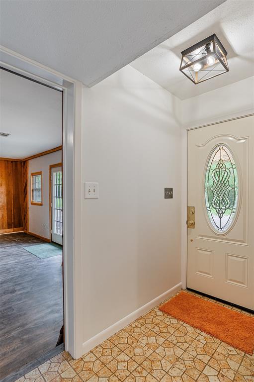 10307 Pirogue Road Oil City, LA 71061 - Photo 4 of 36 a view of an empty room with wooden floor and a window