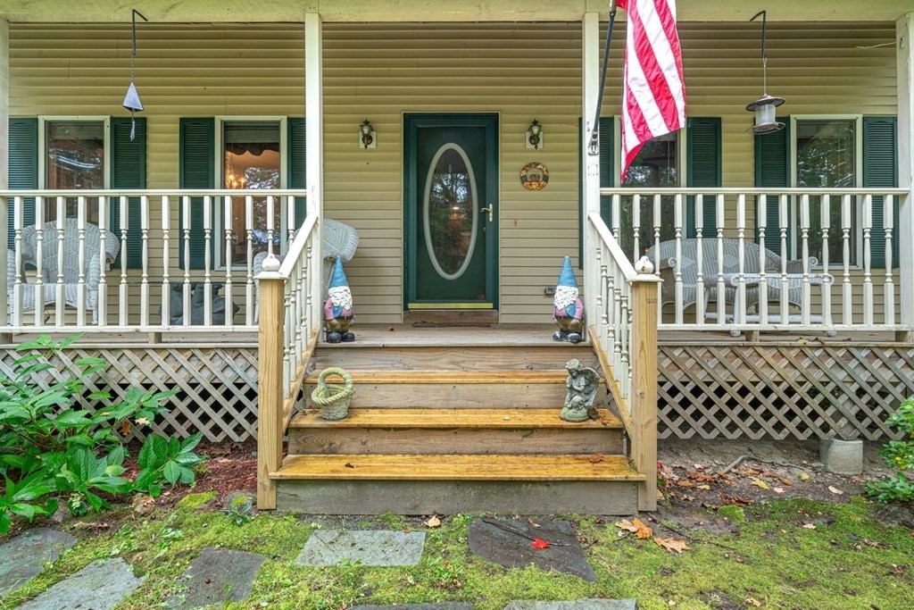 235 Curtis Farm Road Wilton, NH 03086 - Photo 1 of 34 a front view of a house with a garden