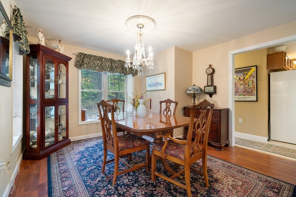 235 Curtis Farm Road Wilton, NH 03086 - Photo 12 of 34 a view of a dining room with furniture window and wooden floor