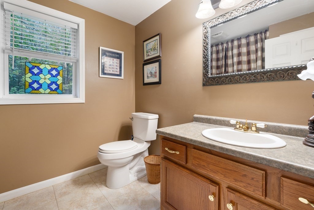 235 Curtis Farm Road Wilton, NH 03086 - Photo 14 of 34 a bathroom with a toilet sink and mirror