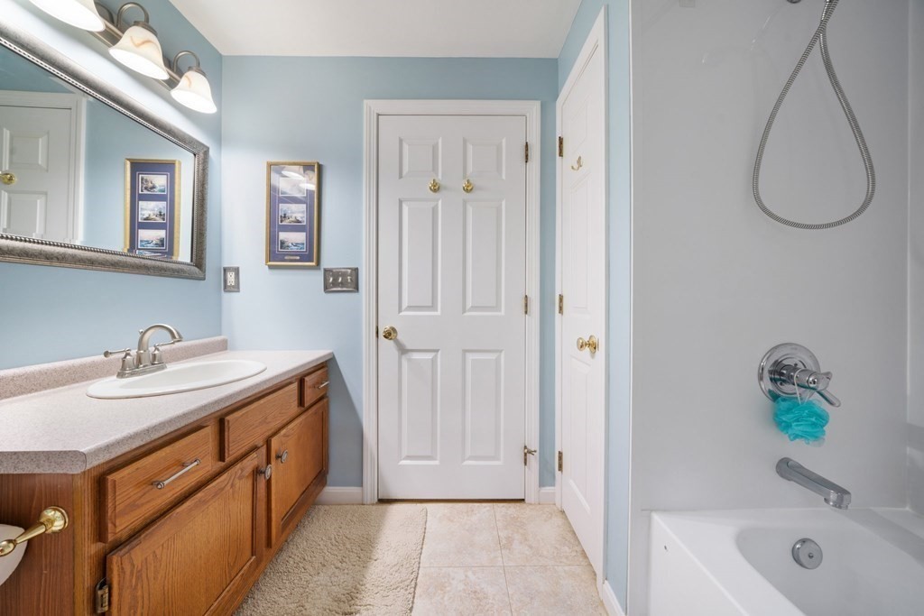 235 Curtis Farm Road Wilton, NH 03086 - Photo 17 of 34 a bathroom with a granite countertop sink and a tub