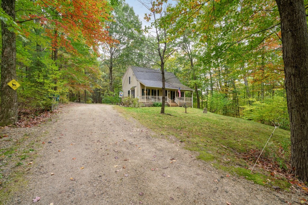 235 Curtis Farm Road Wilton, NH 03086 - Photo 2 of 34 a front view of a house with a yard