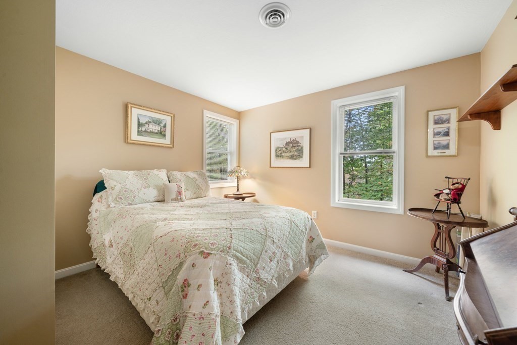 235 Curtis Farm Road Wilton, NH 03086 - Photo 21 of 34 a spacious bedroom with a bed and a window