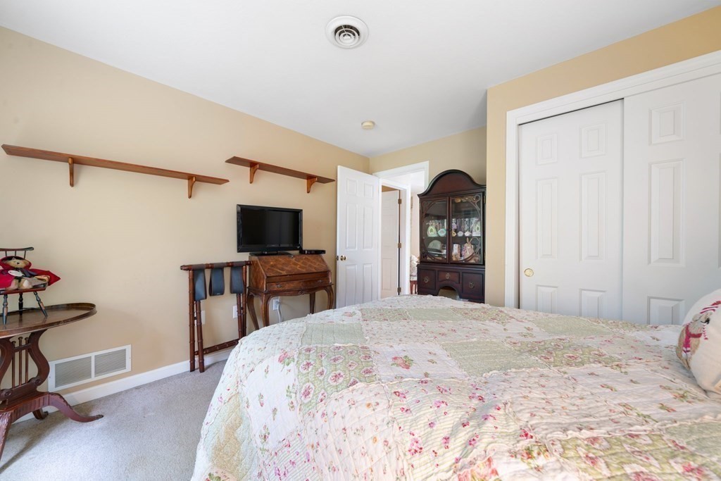 235 Curtis Farm Road Wilton, NH 03086 - Photo 22 of 34 a bedroom with a bed and a flat screen tv