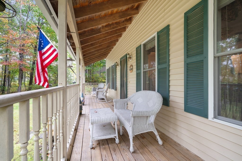 235 Curtis Farm Road Wilton, NH 03086 - Photo 29 of 34 a view of balcony with furniture and wooden floor