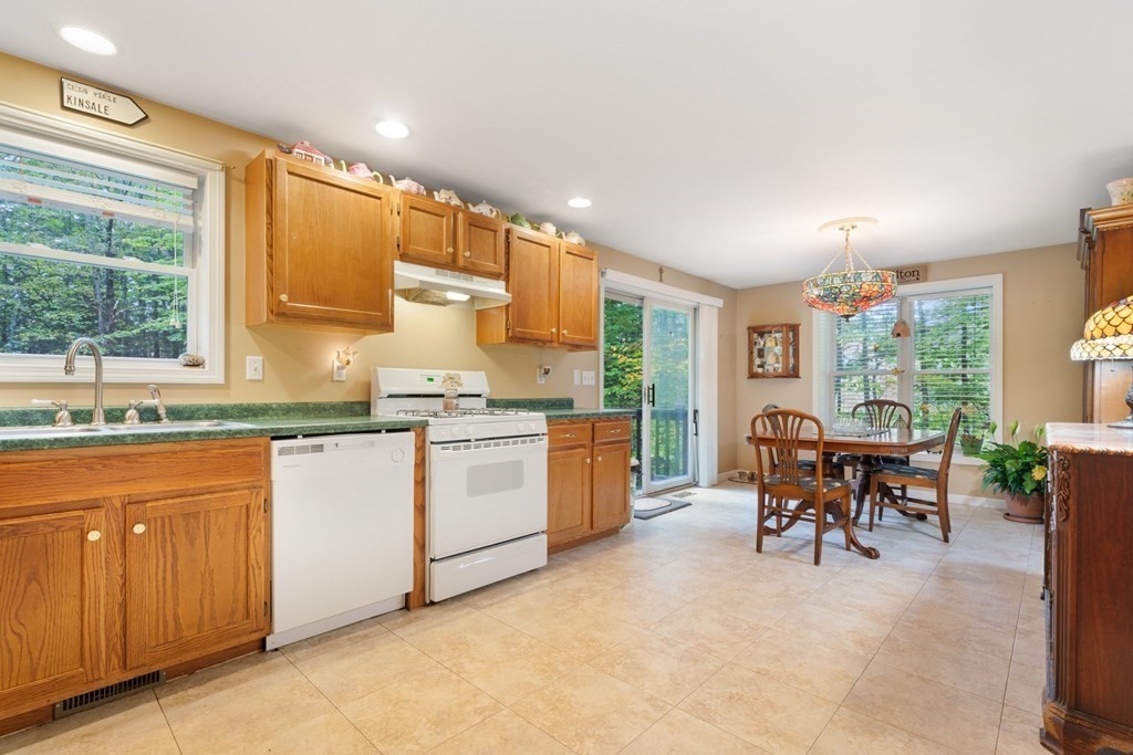 235 Curtis Farm Road Wilton, NH 03086 - Photo 8 of 34 a kitchen with sink cabinets and outdoor view