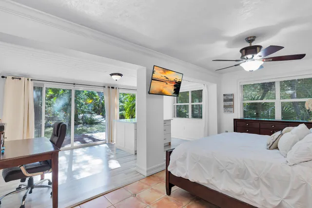 a spacious bedroom with a bed and a cabinets
